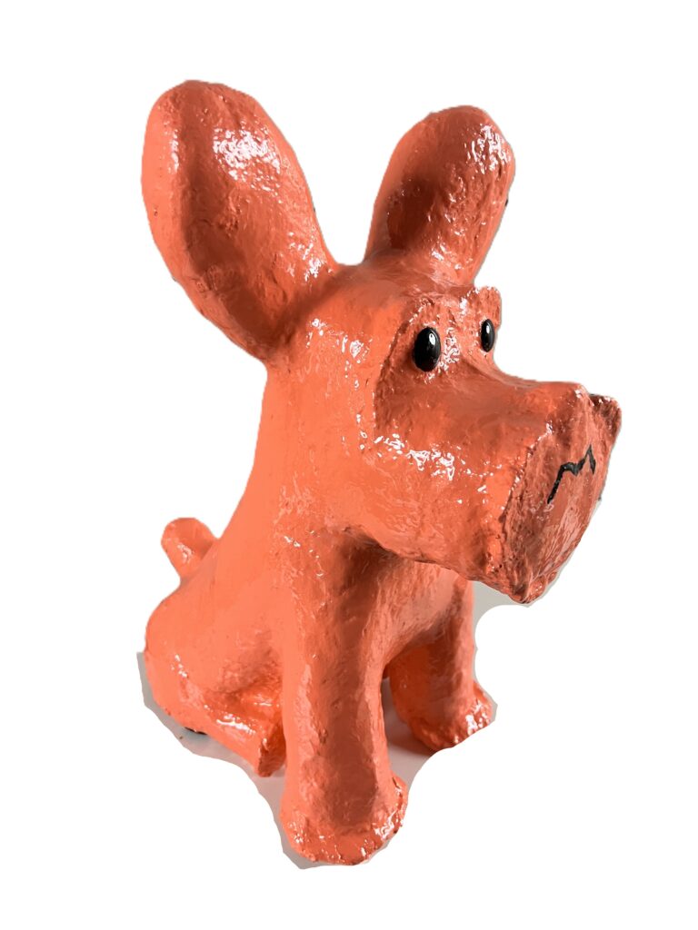 Bright orange dog sculpture with big ears