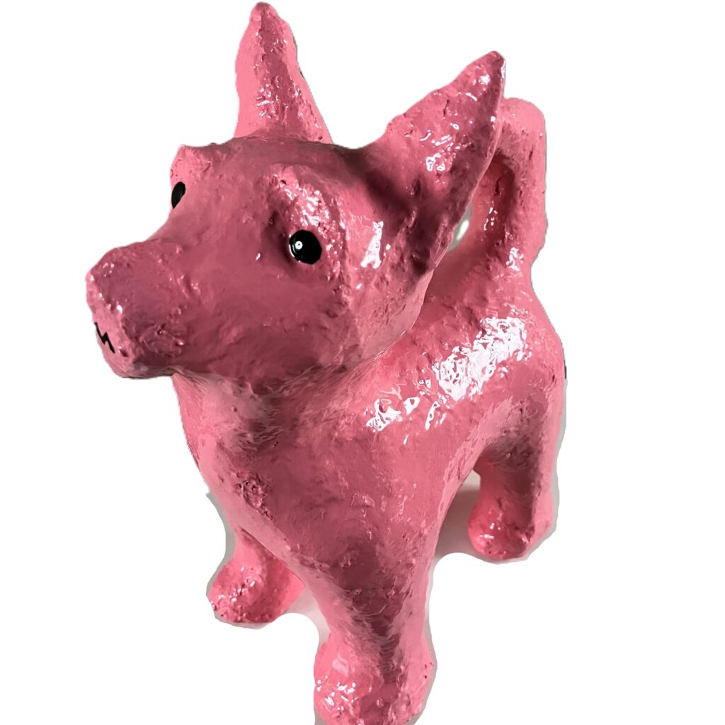 Shiny pink dog sculpture with ears.