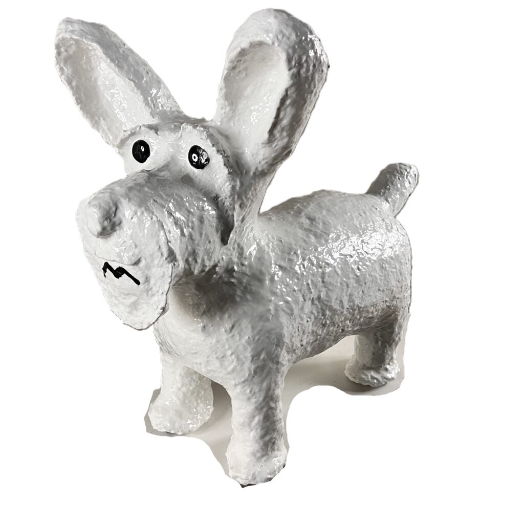 White dog sculpture with big ears.